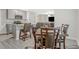 Kitchen and dining space with stainless appliances, breakfast bar, and wood dining table set at 370 Cassidy Trl, Douglasville, GA 30134