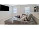 Comfortable loft seating area features a leather sofa, TV, and natural light from the window at 370 Cassidy Trl, Douglasville, GA 30134