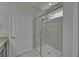 Bathroom with glass shower doors and updated tile surround at 5719 Sierra Bend Way, Hoschton, GA 30548