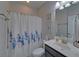 Bathroom featuring a shower curtain with floral design and a modern sink at 5719 Sierra Bend Way, Hoschton, GA 30548