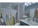 Well-lit bathroom with a modern vanity and a decorative shower curtain at 5719 Sierra Bend Way, Hoschton, GA 30548