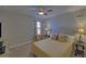 Bright bedroom features a large window, ceiling fan and a comfortable bed with decorative pillows at 5719 Sierra Bend Way, Hoschton, GA 30548