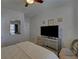 Bedroom with mirrored dresser and large TV at 5719 Sierra Bend Way, Hoschton, GA 30548