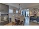 Dining area features a round table, stylish chandelier, and view into the adjoining living room at 5719 Sierra Bend Way, Hoschton, GA 30548