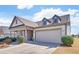 Traditional home with a two-car garage, covered porch, manicured shrubbery, and well-maintained lawn at 5719 Sierra Bend Way, Hoschton, GA 30548