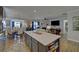 Well-lit kitchen with a large island, open to the living room, and an adjacent dining area at 5719 Sierra Bend Way, Hoschton, GA 30548