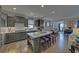 Open-concept kitchen with a spacious island, stainless steel appliances, and abundant natural light at 5719 Sierra Bend Way, Hoschton, GA 30548