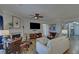 Inviting living room with a fireplace, ceiling fan, hardwood floors, and comfortable seating at 5719 Sierra Bend Way, Hoschton, GA 30548