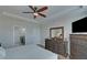 Bedroom featuring hardwood floors, dark wood furniture, a flat screen tv, and access to a bathroom at 5719 Sierra Bend Way, Hoschton, GA 30548