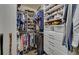 Walk-in closet features custom shelves and racks at 5719 Sierra Bend Way, Hoschton, GA 30548