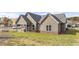 Manicured lawn in backyard with a covered patio and a view of the surrounding community at 213 Saratoga Dr, Acworth, GA 30102