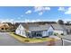 Back view of a home with gray siding featuring an outdoor sitting area and an attached garage, set on a well-manicured lawn at 213 Saratoga Dr, Acworth, GA 30102