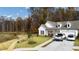 Beautiful white home with a front porch, two-car garage, inviting curb appeal, and a well-manicured lawn at 213 Saratoga Dr, Acworth, GA 30102