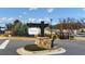 Community entrance sign 'The Artisan at Victory' with lush landscaping and decorative stone at 213 Saratoga Dr, Acworth, GA 30102