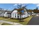 Street corner view of a white home on Saratoga Drive, accented with fall decorations, complemented by a pristine lawn at 213 Saratoga Dr, Acworth, GA 30102