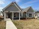 Beautiful one-story house showcasing a covered entry, gray siding, white trim and landscaping at 241 Saratoga Dr, Acworth, GA 30102