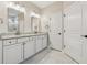 Bathroom featuring double sinks, granite countertops, white cabinets, and marble floors at 2975 Thistle Trl, Suwanee, GA 30024