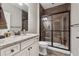 Modern bathroom featuring a tiled shower with glass door and a granite countertop at 2975 Thistle Trl, Suwanee, GA 30024