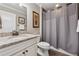 Bathroom vanity featuring granite countertop, grey walls, and a shower at 2975 Thistle Trl, Suwanee, GA 30024