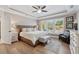 Bright bedroom featuring a tray ceiling, light wood floors, and abundant natural light at 2975 Thistle Trl, Suwanee, GA 30024