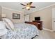 Bedroom features a sleigh bed, ceiling fan, and carpet flooring at 2975 Thistle Trl, Suwanee, GA 30024