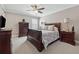 Bedroom with wood furniture, neutral walls, and a ceiling fan at 2975 Thistle Trl, Suwanee, GA 30024