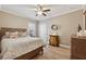 Comfortable bedroom with natural light, hardwood floors, and neutral décor at 2975 Thistle Trl, Suwanee, GA 30024