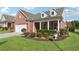 Inviting home with a classic brick facade, dormer windows, and lush front yard at 2975 Thistle Trl, Suwanee, GA 30024