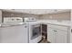 Laundry room with washer, dryer, sink and white cabinets at 2975 Thistle Trl, Suwanee, GA 30024