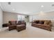 Cozy living area with plush patterned sofas and chair, neutral walls and carpeting at 2975 Thistle Trl, Suwanee, GA 30024