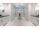 Elegant bathroom featuring dual vanities, white cabinets, and a luxurious shower with multiple shower heads at 3565 Haddon Hall Nw Rd, Atlanta, GA 30327