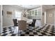 Dining area featuring stylish seating, a round table, checkered floors, and custom built-in cabinetry at 3565 Haddon Hall Nw Rd, Atlanta, GA 30327