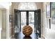 Elegant foyer featuring a dark wood accent table, decor, and front entry doors with glass panes at 3565 Haddon Hall Nw Rd, Atlanta, GA 30327