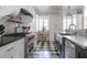 Stylish kitchen featuring stainless steel appliances, a large island, custom cabinetry, and a checkered floor at 3565 Haddon Hall Nw Rd, Atlanta, GA 30327