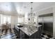 Large kitchen featuring an oversized island with seating, white cabinets, stainless appliances, and checkered tile at 3565 Haddon Hall Nw Rd, Atlanta, GA 30327