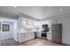 Bright kitchen features stainless steel appliances and white cabinetry at 3565 Haddon Hall Nw Rd, Atlanta, GA 30327