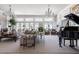 Bright and airy living room with large windows, elegant furnishings, and a grand piano at 3565 Haddon Hall Nw Rd, Atlanta, GA 30327