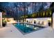 Backyard pool area with lounge chairs and landscape lighting at 3565 Haddon Hall Nw Rd, Atlanta, GA 30327