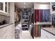 Organized walk-in closet featuring built-in shelving, drawers, and hanging space at 3565 Haddon Hall Nw Rd, Atlanta, GA 30327