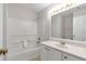 Clean bathroom featuring a shower and tub combination with white cabinets and gold hardware at 4000 Howell Park Rd, Duluth, GA 30096