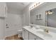 Bathroom featuring dual sinks, tile backsplash, and tub with tile surround at 4000 Howell Park Rd, Duluth, GA 30096