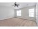 Large bedroom filled with natural light, ceiling fan, and neutral carpet at 4000 Howell Park Rd, Duluth, GA 30096