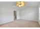 Neutral bedroom featuring ceiling fan and ample natural light from a large window at 4000 Howell Park Rd, Duluth, GA 30096