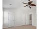 Spacious bedroom featuring neutral walls, carpet flooring, and a decorative ceiling fan at 4000 Howell Park Rd, Duluth, GA 30096