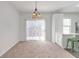 Dining area featuring a hanging light fixture, sliding glass doors, and an open floor plan at 4000 Howell Park Rd, Duluth, GA 30096