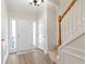 Inviting home entrance featuring wood floors, staircase, and elegant white trim at 4000 Howell Park Rd, Duluth, GA 30096