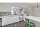 Open kitchen layout with white cabinets and a breakfast bar overlooking the living space at 4000 Howell Park Rd, Duluth, GA 30096