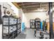 Organized basement storage area with shelving and exercise equipment on a gray concrete floor at 57 Rumson Ne Way, Atlanta, GA 30305