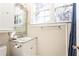 Cozy bathroom featuring a marble countertop vanity, lots of natural light, and a shower with a blue curtain at 57 Rumson Ne Way, Atlanta, GA 30305