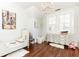 Charming bedroom with hardwood floors, a crystal chandelier, and a light-filled window at 57 Rumson Ne Way, Atlanta, GA 30305